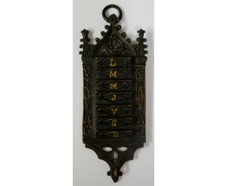 A small French Gothic style hanging weekly planner, with small indents for each day of the week, gilded letter on each indent