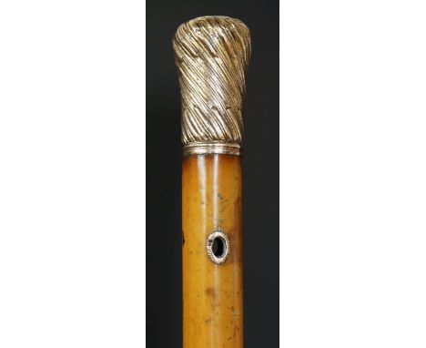 A Georgian Malacca walking stick with spirally fluted and stop fluted gold coloured metal bun shaped top and eyelets, brass f