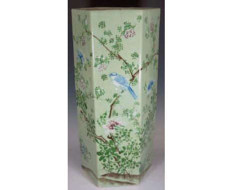 A Chinese Famille Verte hexagonal stick stand decorated overall with birds amidst flowers and leafage on a pale celadon groun
