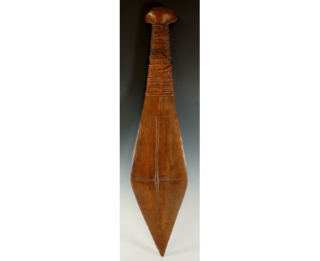 A Solomon Islands tribal club of paddle .form with knotted woven grip and axe head terminal, 63cm long, 19th Century