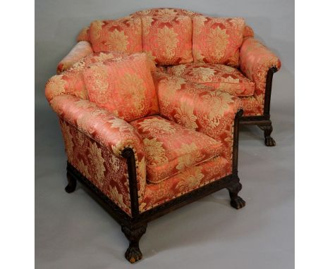 An Edwardian mahogany sofa in George III style the frame carved with Vitruvian scroll on hairy paw acanthus carved squat feet