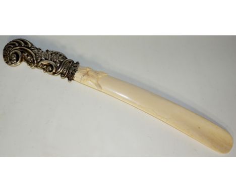 A Victorian silver mounted ivory page turner the tapered blade finely carved with a finch the handle C-scroll, flower and lea