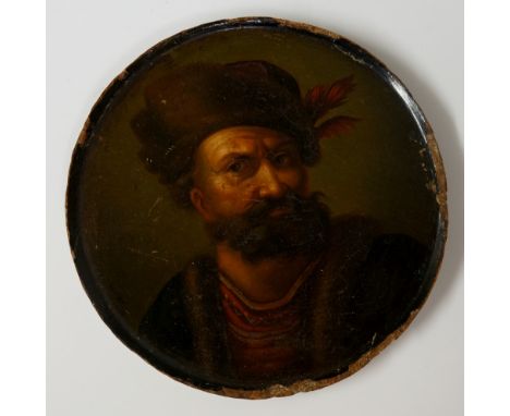 A circular papier maché snuff box lid, decorated with a bearded gentleman in 17th Century attire, head and shoulders, indisti