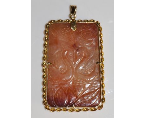 A Chinese gold coloured metal mounted rectangular jade plaque pendant finely relief carved with pair of stylised birds and lo
