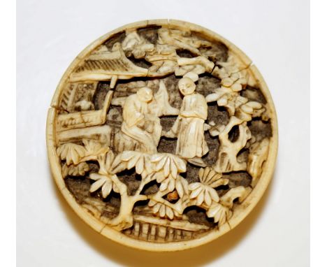 A Cantonese ivory cylindrical box and cover finely relief carved with figures in landscapes and houses amidst trees, containi