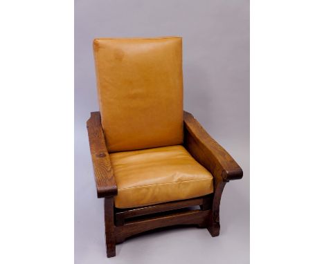 Robert Thompson Of Kilburn - an English oak reclining "smoking"chair with flat tapered arms with scrolling terminals, ladder-