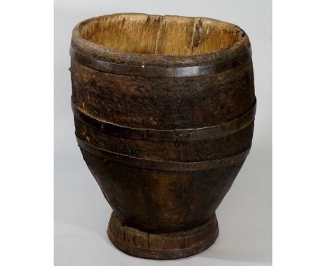A coopered elm trunk section with four wrought iron bands, stapled interior bearing covered lock provision, 56cm diameter, 72