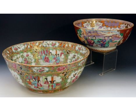 A Cantonese Famille Rose circular bowl decorated in typical palette with reserves of figures in temple landscapes, birds and 