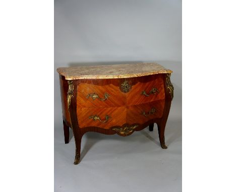 A Louis XVI mahogany and kingwood commode the serpentine-shaped marble above two long drawers, brass foliate mounts and sabot