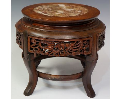 A Chinese hardwood stand the top inset with rosso marble circular panel the frieze carved with Dragon Chasing The Flaming Pea