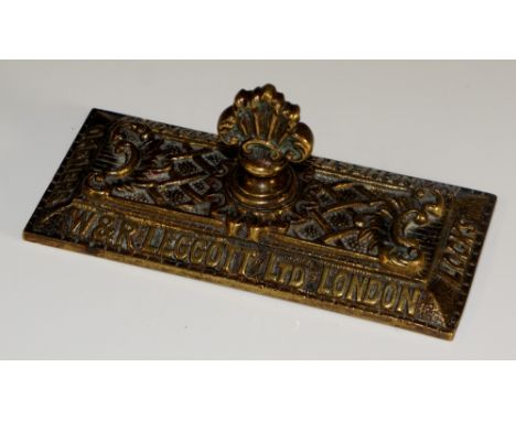 A brass  paper weight bearing 'W&R Leggott Ltd London, Locks, Manchester & Bradford, Openers' to outer edge, floral scrolling