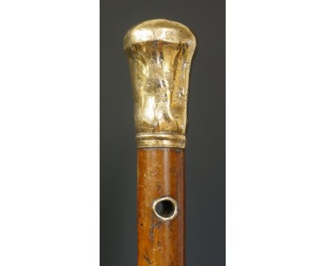 A Georgian Malacca walking stick with foliate engraved gold coloured metal top and eyelets, brass ferule, 87cm high