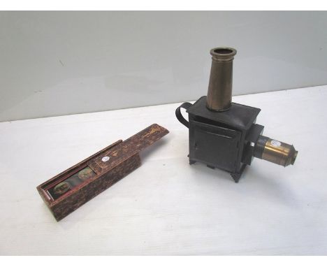 A small early 20th Century tin plate magic lantern with oil burner and glass chimney together with a box of childrens magic l