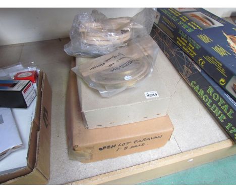 Two boxed unmade wooden model kits 1/8th scale, milk float and open caravan together with a selection of wooden kit wheels 
