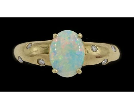 9ct gold opal ring, either side with three rubover set, round brilliant cut diamonds, Sheffield 2004Condition Report:Approx 2