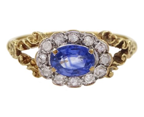 9ct gold oval sapphire and diamond cluster ring, with split design shoulders, London 1987, sapphire approx 0.60 caratConditio