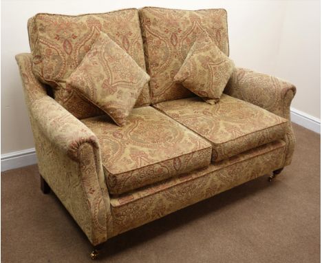 Two seat sofa upholstered in beige floral patterned chenille fabric, turned supports, brass castors (W155cm) a pair matching 