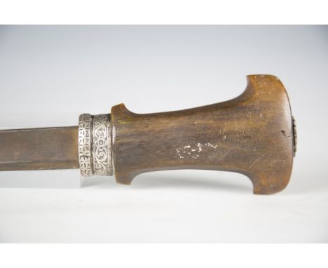 A 19th century North African short sword with single-edged fullered blade, blade length 53cm, and one-piece rhino horn grip w