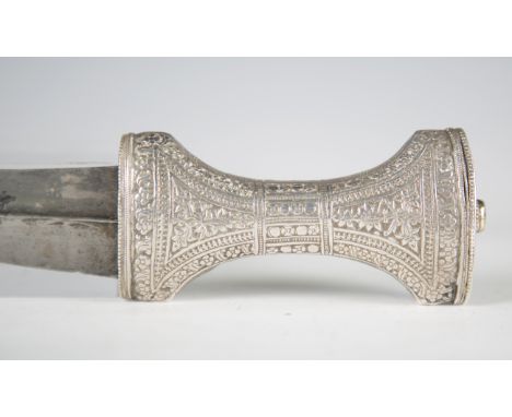 A late 19th century Middle Eastern silver mounted jambia with curved blade, blade length 19cm, and chased and engraved silver