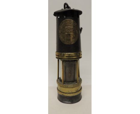 A miners lamp by Achroyd & Best Ltd "Hailwoods Improved Lamp" with brass makers plate and original suspension hook, 26cms hig