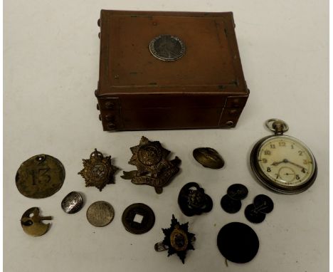 An open face pocket watch the back with War Dept arrow and GSTP; a brass Worcestershire cap badge; other badges; a George III