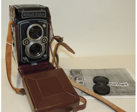 A Franke & Heidecke Rolleiflex camera having Synchro-Compur shutter and in original brown leather case and with a copy of ins
