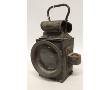 A War Department Miller lamp with clear glass front and red glass back panel, the top with "WD" and arrow mark, 23cms high in