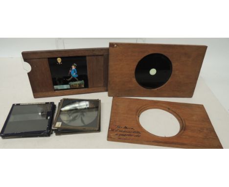 A mechanical magic lantern slide, the wood slide with coloured image of man falling into a river; two other slides and some s