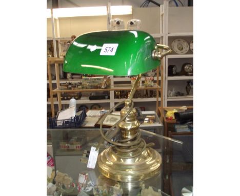 A brass desk/bankers lamp with green glass shade