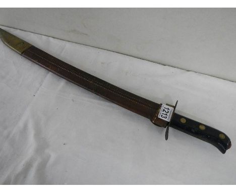 A good old machete in leather scabbard, overall length 54 cm.