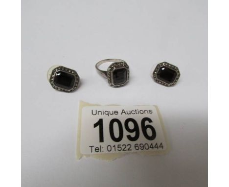 A silver ring (size M) with matching earrings.