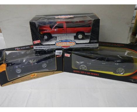 A 1:14 scale radio control BMW, An ERTL Dodge Ram 2500 SLT and a Maisto Aston Martin DB7 Vantage.