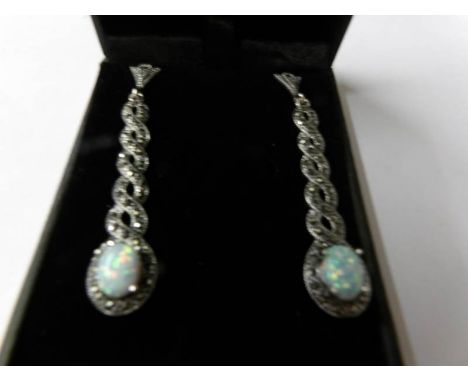 A pair of silver marcasite and opal paneled drop earrings.