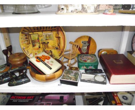 A shelf of misc. wooden items, tins, flat irons etc.