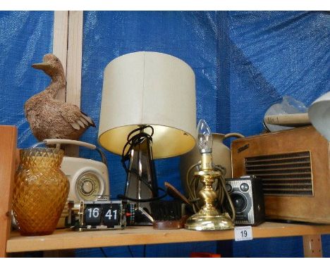 A shelf of radio's, lamp etc.,