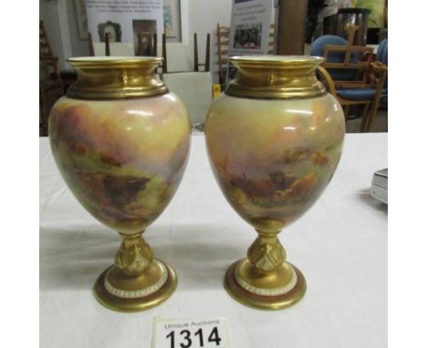 A pair of Royal Worcester porcelain ovoid vases, the moulded neck gilded, the body decorated with Highland cattle, raised on 