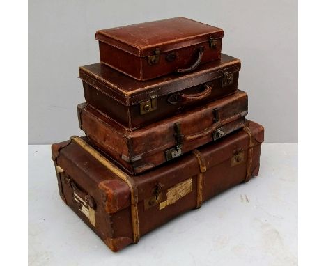 A set of four graduated vintage suitcases 