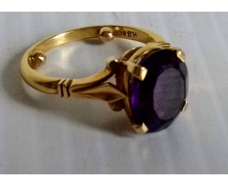 A mid-century oval-cut amethyst (12mm x 10mm approx.) ring in an 18ct yellow gold cage setting, hallmarked, size L, 5.64g 