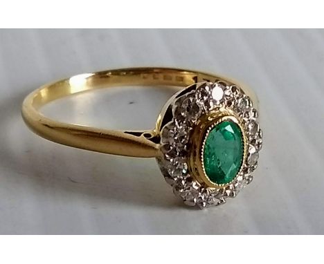 An Edwardian peridot and diamond cluster ring on an 18ct yellow gold mount, hallmarked, size T, 3.6g 