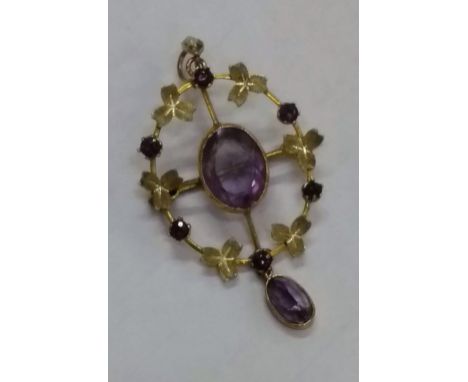 An Edwardian oval amethyst (8mm x 10mm) brooch with pendant, 50mm x 25mm, stamped 9ct, 3g
