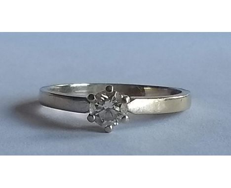 An 18ct white gold solitaire diamond ring, round brilliant-cut, approximately 0.2 carat, stamped 750, size N, 2.75g 