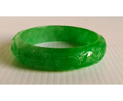 A Chinese jade bangle, 6.5 cm internal diameter 