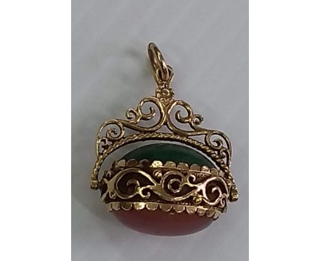 A 9ct gold swivel Albert fob with hardstone cabochons, hallmarked, 9.16g and a George VI silver bangle with floral etched dec