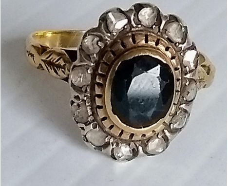 A 19th century oval sapphire and diamond cluster ring in a yellow and white gold basket setting (testing for 18ct gold), comp