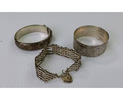 Two mid-20th century silver bangles and a silver gate-link bracelet, mixed dates (3) 