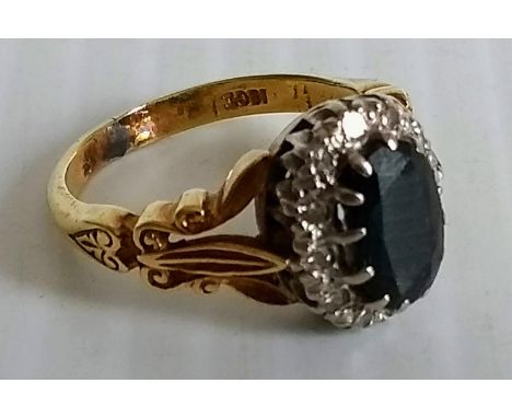 A Victorian oval sapphire and diamond cluster ring, (sapphire 9mm x 6mm approx) stamped 18ct, size M, 6.69g 