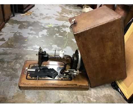 Three vintage sewing machines in cases including Jones