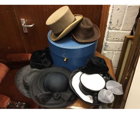 Hat box containing vintage ladies hats, beige felt top hat (size 7 1/8) and brown trilby hat