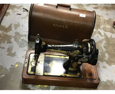 Four vintage sewing machines in cases including Singer