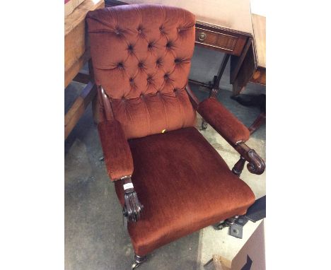 Victorian armchair with button back upholstery, standing on slender turned legs